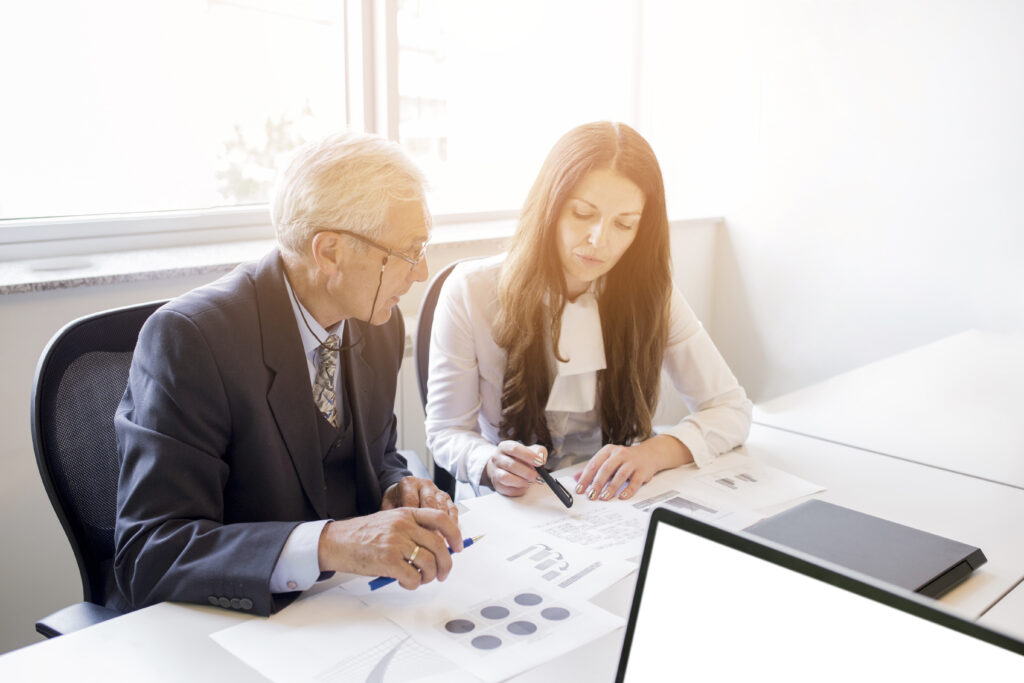 Our Goals businessman businesswoman discussing business plan with chart.jpg